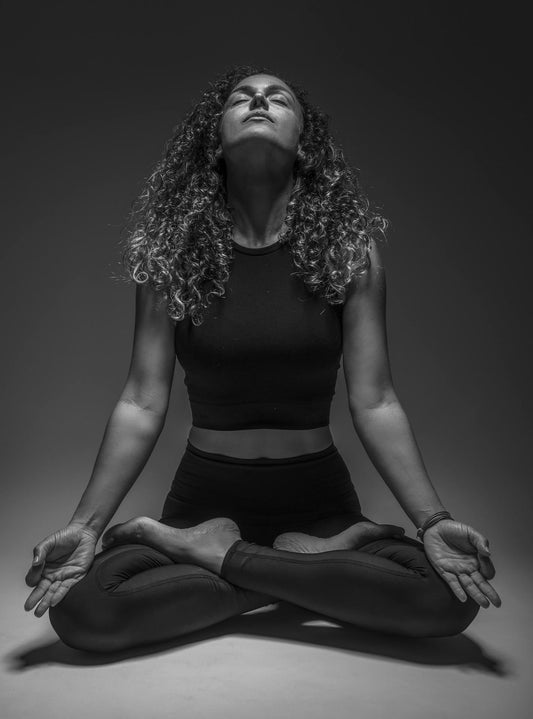 photo en noir et blanc d'une femme qui fait du yoga