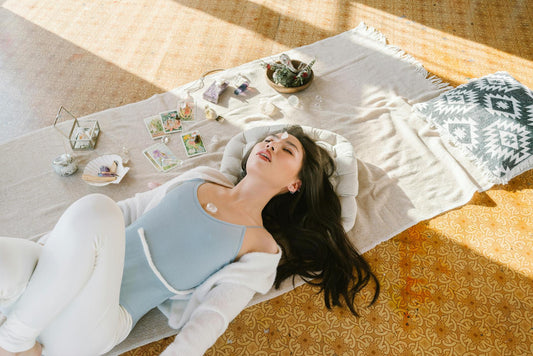 femme alongée au sol qui fait de la méditation 